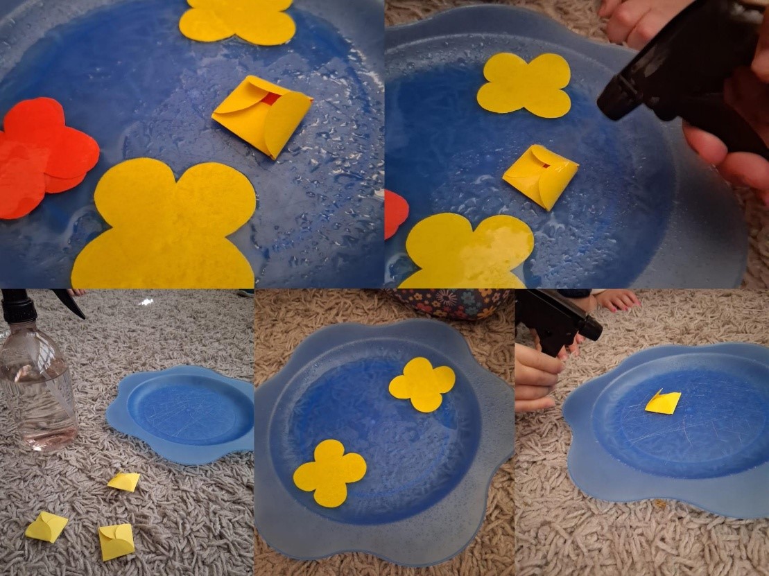Collage. Gelbe, gefaltete Papierblumen werden mit Wasser besprüht und "blühen" dadurch auf